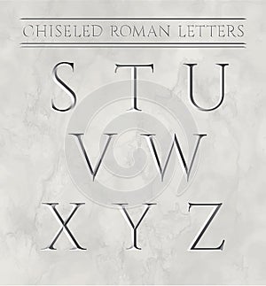 Roman letters chiseled in marble stone. photo
