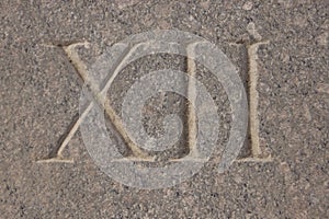 Roman numeral - twelve carved in stone