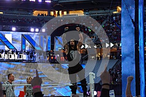 Roman Reigns wrestler stands on top turnbuckle with arms in the