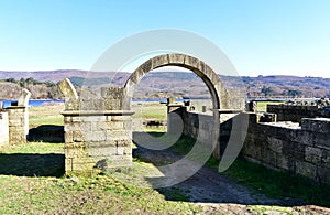 Roman ruins with lake. Aquis Querquennis archaeological site, arched stone door. BaÃÂ±os de Bande, Orense, Spain. photo
