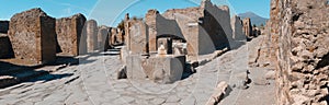 roman ruins in pompeii with fountain public at a crossroads, wit