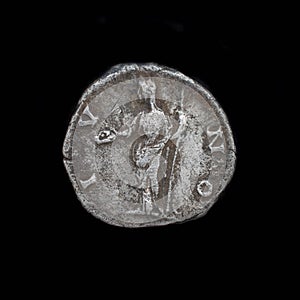 Roman silver denarius isolated on black background. Ancient roman silver coin. Faustina II silver denarius 175 AD. Roman silver.