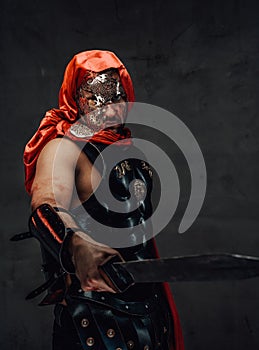 Roman slayer with hood and mask psoes with sword