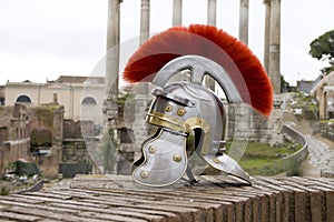 Roman soldier helmet in front of ancient roman ruins.