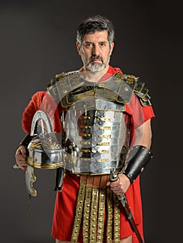 Roman soldier posing holding his helmet