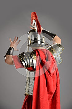 Roman soldier protecting himself and facing away