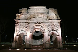 Roman triumphal arch of Orange lit up at night