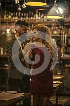 Romance. couple in love in cafe of man wearing fur to woman