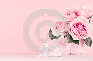 Romance festive interior - delicate pastel pink flowers, gift box, heart with gentle ribbon and bow on white wooden table.