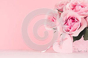 Romance festive interior - delicate pastel pink flowers and heart with gentle ribbon and bow on white wooden table, copy space.