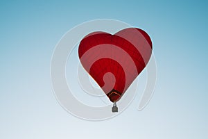 The romance of flying in a balloon in the shape of a red heart