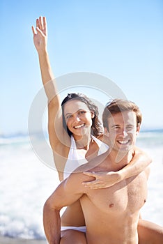 Romance and fun under the sun. A lovely young couple having fun on the beach in summer.