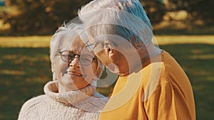 Romance at old age. Retired couple enjoying autumn picnick. Looking at each other