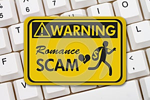 Romance Scam warning sign on a keyboard