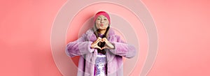 Romance and valentines day. Happy asian senior woman showing heart sign, I love you gesture, pucker lips for kiss