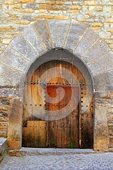 Romanesque arch door wooden medieval Ainsa photo
