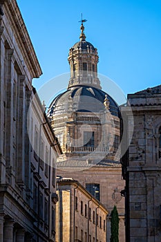 Romanesque domes of the clereatic tower of the old cathedral of Salamanca from the medieval street of the booksellers. photo