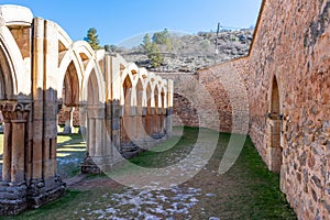 Romanesque monastery courtyard with stone arches