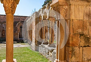 Romanesque monastery courtyard with stone arches