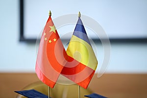 Romania and China flags one next to the other on a table. China-Romania bilateral relations