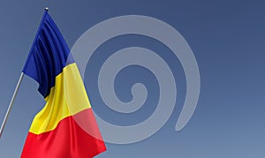 Romania flag on flagpole on blue background. Place for text. The flag is unfurling in wind. Europe, Bucharest. Romanian. 3D