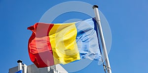 Romania flag waving against clear blue sky