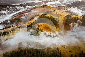 Romania landscape on a foggy autumn morning in Fundata, Brasov on the Rucar Bran pass. photo