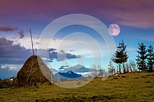 Romania.Transylvania.Bran village.Sky at dusk and full moon in the countryside