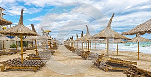 Romanian beach in a windy day, terrace with straw umbrellas