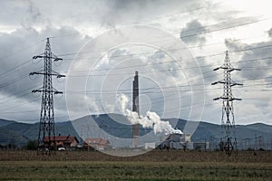 Romanian coal power plant with electricity power lines in front. Despite reforms, Romania is still producing polluting energy