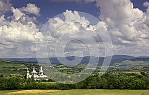 Romanian countryside - white church and rural land