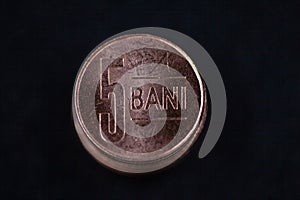 Romanian currency (Bani, RON, Romanian Leu) stockpiled per value seen from above centered on a dark background