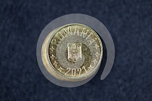 Romanian currency (Bani, RON, Romanian Leu) stockpiled per value seen from above centered on a dark background