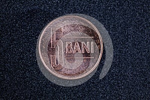 Romanian currency (Bani, RON, Romanian Leu) stockpiled per value seen from above centered on a dark background