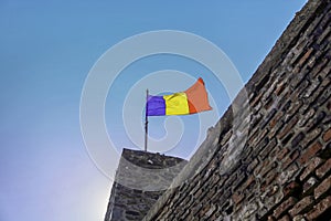 Romanian Flag atop a Brick Wall of Poenari Fortress Castle: A Symbol of Pride and Heritage