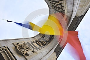 Romanian flag hanging on triumphal arch in Bucharest