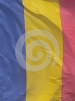 Romanian flag, hoisted, waving in the wind in the sun