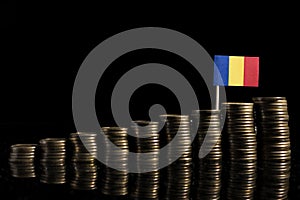 Romanian flag with lot of coins on black