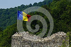 Romanian flag on ruined castle Poenari, Dracula castle, Romania