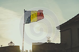 Romanian flag is waving with sunset in background