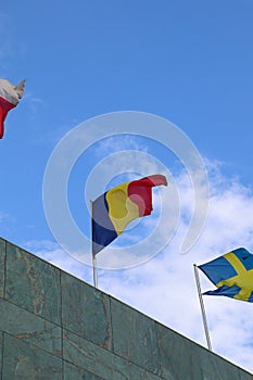 The Romanian Flag Waving on Top of the Building with Other Nations\' Flags