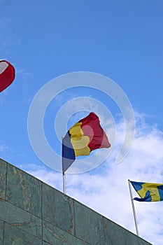 The Romanian Flag Waving on Top of the Building with Other Nations\' Flags