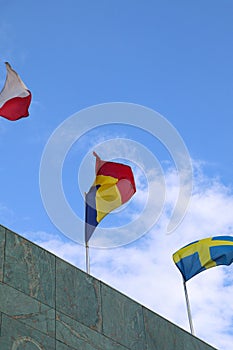 The Romanian Flag Waving on Top of the Building with Other Nations\' Flags