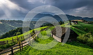 Romanian hillside and village in summer time , mountain landscape of Transylvania in Romania