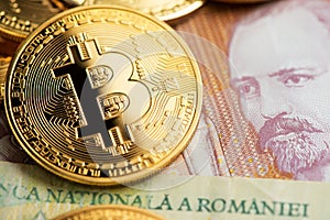 Romanian Lei banknotes with golden Bitcoin BTC Cryptocurrency coins.