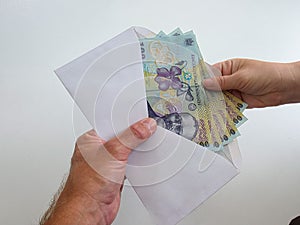 Romanian Lei 100 RON bank notes in an envelope