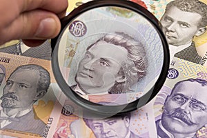 Romanian leu in a magnifying glass