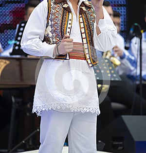 Romanian national costume on singer performing on stage