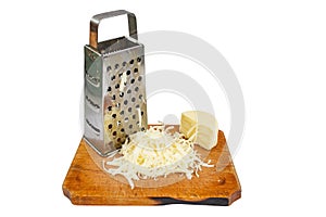 Romanian pressed cheese called cascaval, grated on a chopping board, isolated on white