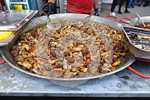 Romanian traditional meat stew being cooked in a huge pan at an outdoor food festival photo